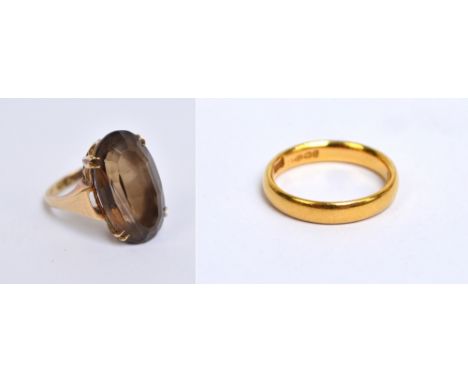 A 22ct yellow gold wedding ring of rounded form, size K and a 9ct yellow gold dress ring set with an oval quartz stone, size 