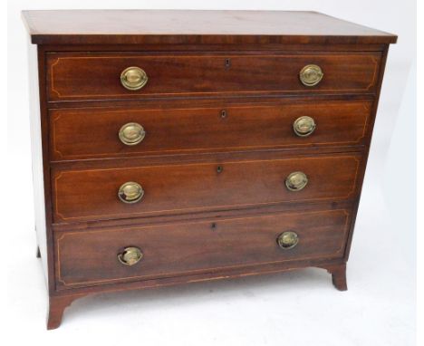 An early 19th century mahogany crossbanded and boxwood strung chest of four long graduated drawers raised on splayed bracket 