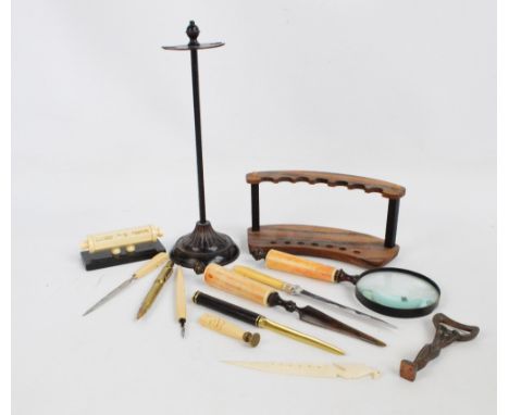 A seven section curved pen display stand, a magnifying glass and matching paper knife, a French desk calendar, etc.