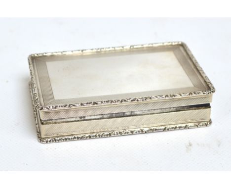 A large Elizabeth II hallmarked silver snuff box of rectangular form with engraved engine turned decoration and gilt washed i