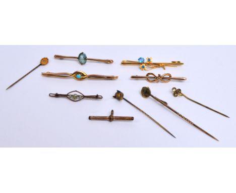 A collection of tie pins and stick pins including a 9ct gold tie pin with pierced frame centred with a turquoise, length 7cm,