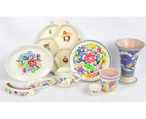 Nine pieces of Poole Pottery including a flared floral decorated vase by Marion Heath, height 23.5cm.