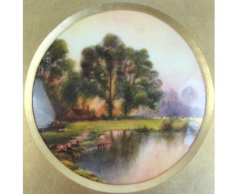 A Royal Worcester porcelain circular plaque hand painted with a landscape with lake, a cottage and ducks, signed R Rushton lo