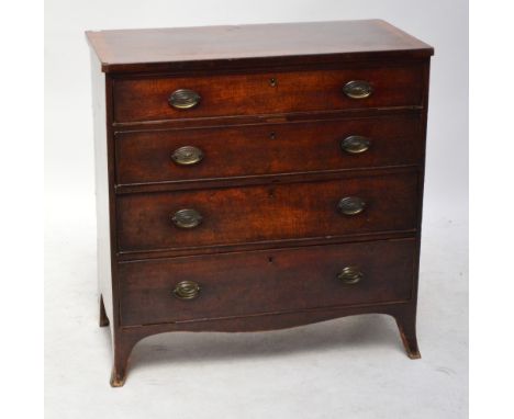 An early 19th century oak chest of drawers, the top with crossbanded decoration, with four long drawers and outswept bracket 