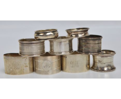 A group of eight variously hallmarked silver napkin rings to include a pair of plain curved form initialled "MPD", William Hu