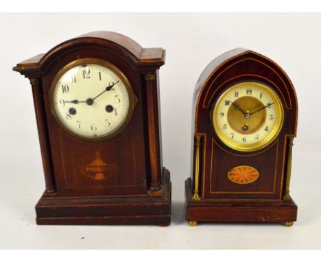 An Edwardian mahogany and inlaid lancet shaped thirty hour mantel clock, the circular dial set with Arabic numerals, on brass