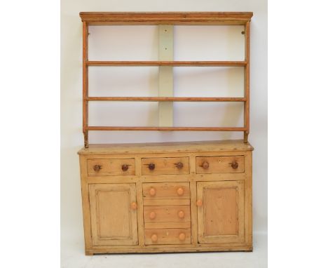 A Victorian pine Welsh dresser base with three frieze drawers above three simulated drawers acting as cupboard doors flanked 