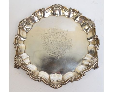 A Victorian hallmarked silver shaped circular waiter with scallop and scroll decorated piecrust rim, centred with an engraved