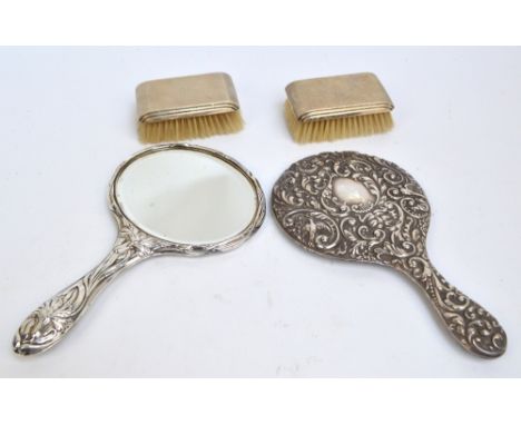 A cased pair of Elizabeth II hallmarked silver backed Art Deco style brushes of rectangular forms with stepped sides and over