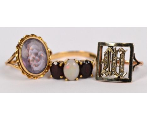 A 9ct yellow gold opal and garnet ring, with high claw heart motif decorated setting, size R, a further gold ring with oval f