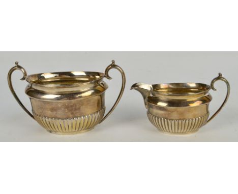 A late Victorian hallmarked silver three piece tea service of oval form with part gadrooned body, Pearce & Sons, Sheffield 18