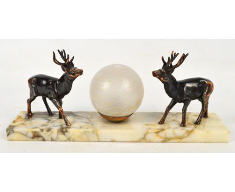 A French Art Deco style lamp, the rectangular marble base centred with a frosted glass lobe (af), and flanked by spelter stag