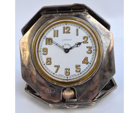 A George V hallmarked silver Art Deco style crown wind travelling eight day clock of octagonal form with overall engine turne