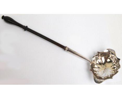 A George II hallmarked silver toddy ladle with shaped oval double lipped bowl with tapering stem and turned wooden handle, in