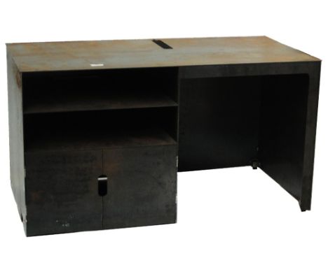 An unusual steel desk, the rectangular top with groove cut for depositing stationery beneath, above a kneehole to the right h