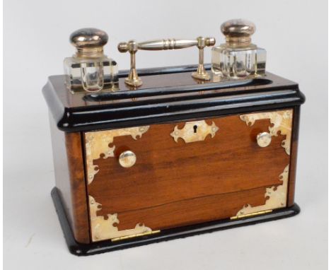 A Victorian walnut silver plate mounted and ebonised inkstand/cabinet, the central carrying handle flanked by sectioned glass