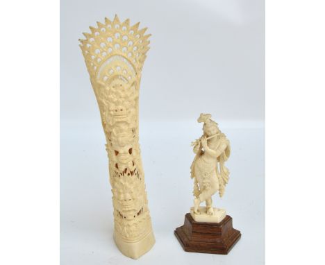 A c.1900 Indian carved ivory figure of Krishna playing a flute, on wooden wedge shaped base, height 14.5cm (af) and a further