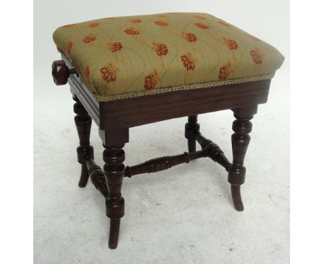 A late 19th/early 20th century upholstered piano stool with adjustable seat, width including side winding wooden knobs 53cm.