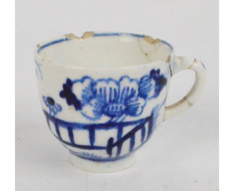 A rare 18th century Worcester miniature or toy cup painted with blue and white floral sprays beside a fence with touch of blu