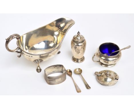 A George V hallmarked silver sauce boat with C-scroll handle and hoof feet with shell shouldered beaded rim, William Hutton, 