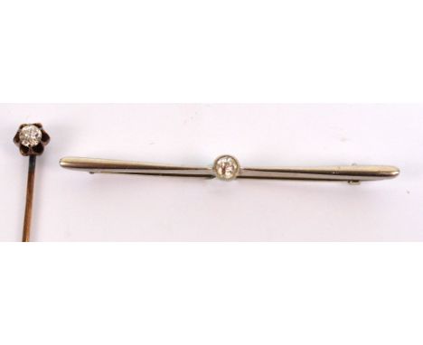 An 18ct white gold and diamond tie pin, the collet set stone approx 0.15cts, length 5.5cm and a further diamond stick pin app