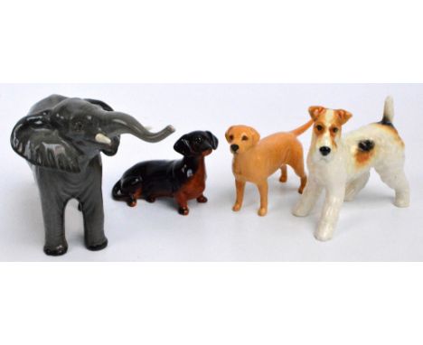 Four figures of Beswick animals; "Terrier - walking", no. 1062, "Dachshund - seated", no. 1460, "Labrador - small", no. 1956,