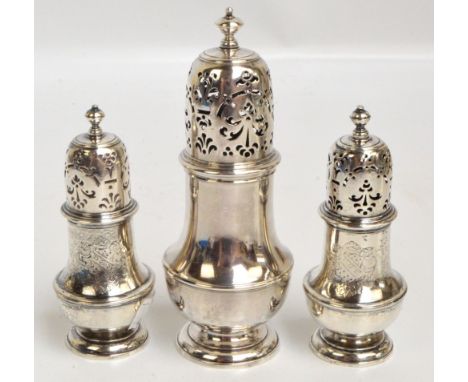 A set of three George II hallmarked silver sugar casters comprising a single larger example and a smaller pair of baluster fo