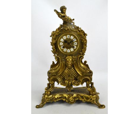 A large decorative mid 20th century French gilt metal mantel clock with painted Roman numerals to the enamel plaques and with