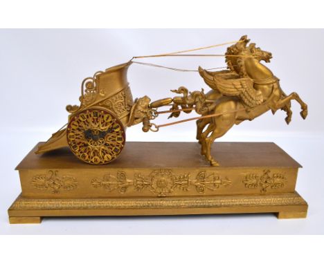 A late 19th century French gilt spelter mantel clock modelled as a chariot being drawn by two winged horses, the drum type mo