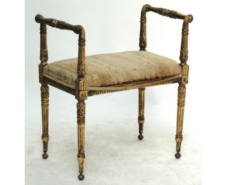 A c.1900 French gilt wood stool/window seat in the Louis XIV manner, the shaped uprights with acanthus carved scrolling handl