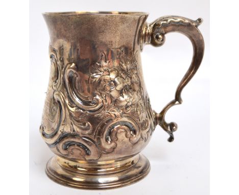 A George IV hallmarked Irish silver mug of baluster form with leaf capped S-scroll handle, with presentation inscription "Fir