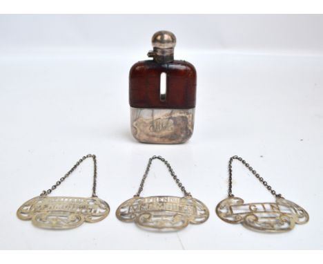 A set of three George V hallmarked silver bottle labels for "Gin", "French Vermouth", and "Italian Vermouth", all suspended o