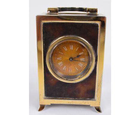 A George V leather cased tortoiseshell and silver gilt mounted miniature carriage clock, the swing loop handle above circular