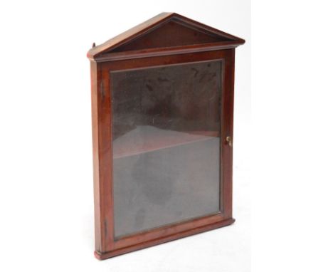 A 20th century mahogany wall mounted corner display cabinet with plain pediment, hinged glass door enclosing a single shelf a