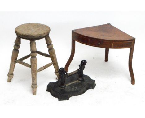 A rustic pine four legged milking stool with turned legs, height 50cm, a cast iron boot scraper with scrolling ends and shape