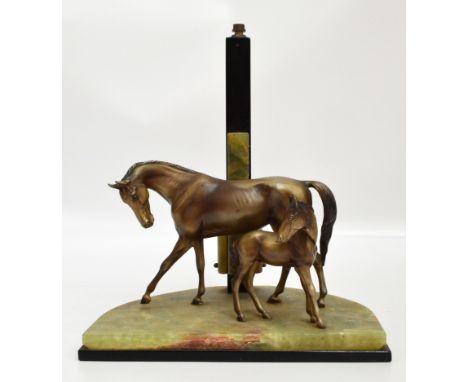 An Art Deco lamp in the form of a mare and foal on a shaped onyx base with onyx and black upright, width 26cm, height excludi