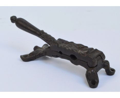 A Victorian cast iron cork compressing tool with divisions for two different sized corks, length 22cm.