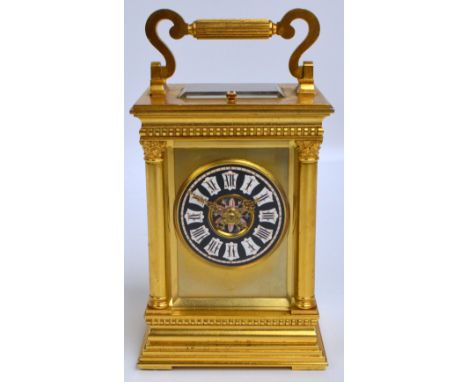 A late 19th/early 20th century French gilt metal repeating carriage clock with swing loop handle above enamelled painted dial