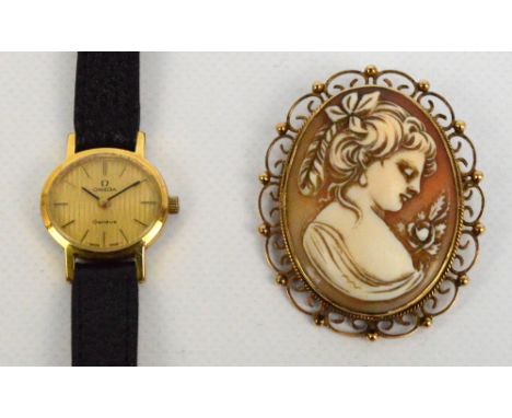 OMEGA; a lady's manual wind gold plated cased wristwatch, the oval engine turned decorated dial set with baton numerals on le