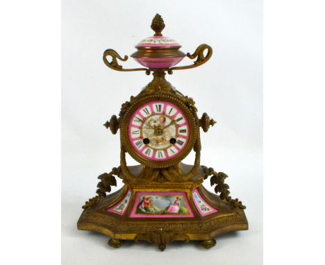 A late 19th century French gilt metal and porcelain mounted mantel clock, the urn shaped finial above circular dial set with 