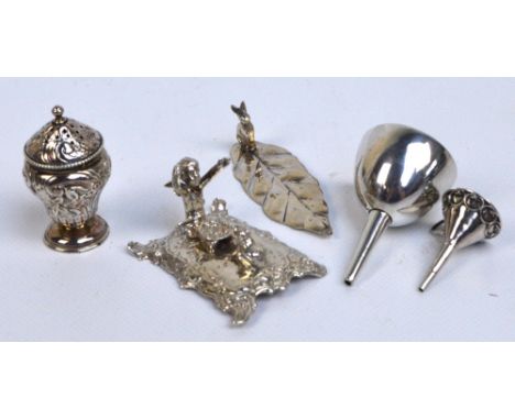 A 19th century miniature German silver figure group modelled as a kneeling cherubic figure with a bowl on his lap before a fr