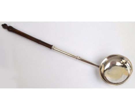 A c.1740 English provincial silver ladle with plain circular bowl and knopped tapering stem with turned wooden handle, maker'