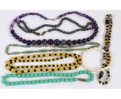 A mixed collection of jewellery including an amethyst necklace, freshwater pearl necklace, etc.