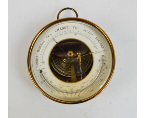 An early 20th century lacquered brass cased circular aneroid barometer with ring loop attachment, diameter 13.5cm. CONDITION 