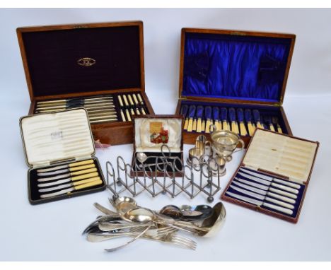 A large quantity of electroplated items including an entree dish, cased sets of knives, a ladle, serving spoons, other flatwa