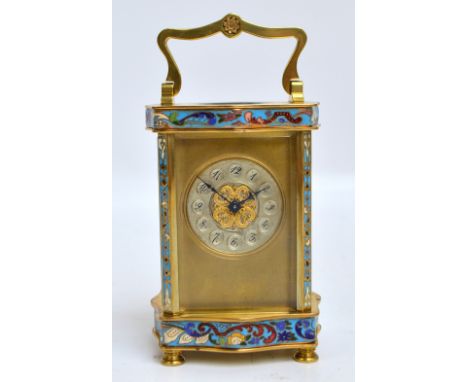 A reproduction brass and enamel decorated carriage clock, the swing loop handle above silvered circular chapter ring set with