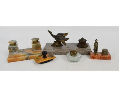 A French Art Deco style inkstand with rectangular marble dish for a pen rest, set with a gilt spelter bird beside an inkwell,