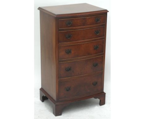 A reproduction walnut veneered five drawer chest on bracket feet, width 52cm.
