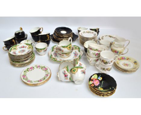 A quantity of teaware including Aynsley black and floral decorated cups and saucers, Royal Standard, Colclough, Grosvenor, et
