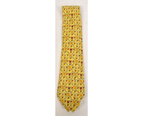 HERMES; an Hermes vintage silk tie in a trellis, trailing rose and butterfly pattern on a yellow ground, in an orange Hermes 